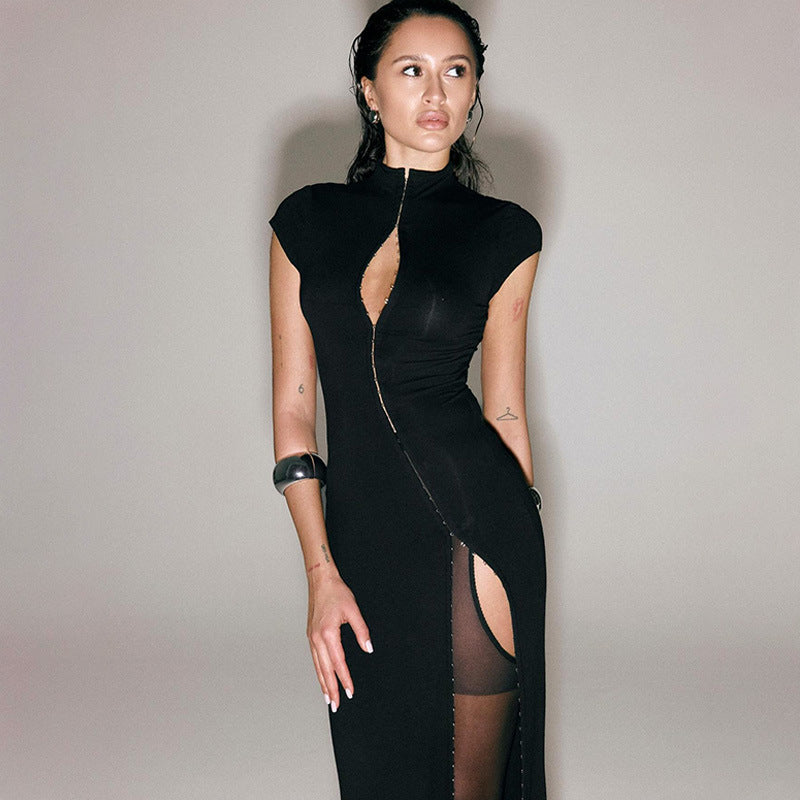 High-necked, floor-length gown with cutouts at the chest and a high slit.