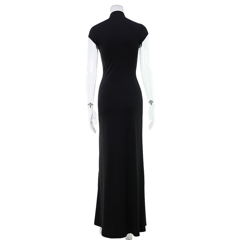 High-necked, floor-length gown with cutouts at the chest and a high slit.